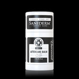 A white cylindrical container of Saniderm Small Aftercare Balm with black and white labels, centered against a solid black background.