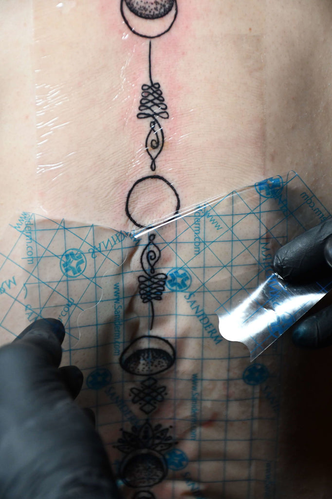 cropped shot of tattoo artist transferring tattoo sketch on shoulder in  tattoo salon Stock Photo  Alamy